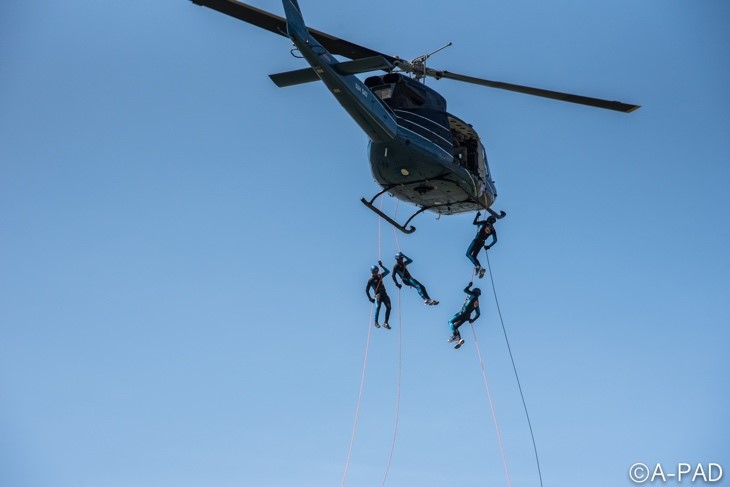 Four trainees rappel from a helicopter as part of the swift water rescue SAR training. (Photo Credit: A-PAD SL)