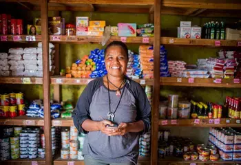 A woman stands in her store in Vanuatu