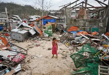 Child in the middle of damaged houses