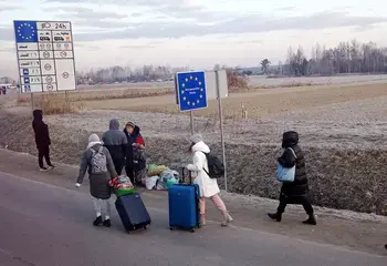 People cross the border from Ukraine into Poland on 27 February 2022