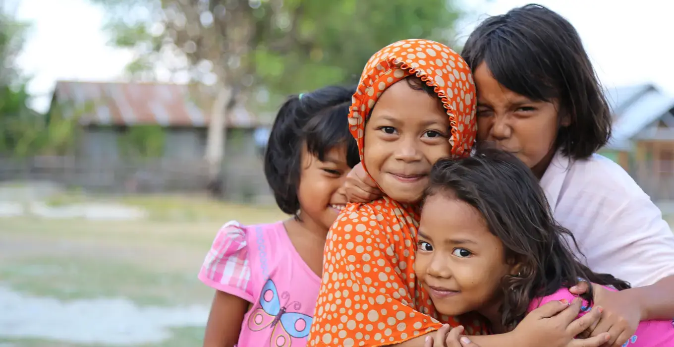 Children in tsunami-striken Sulawesi region in Indonesia smile at the camera