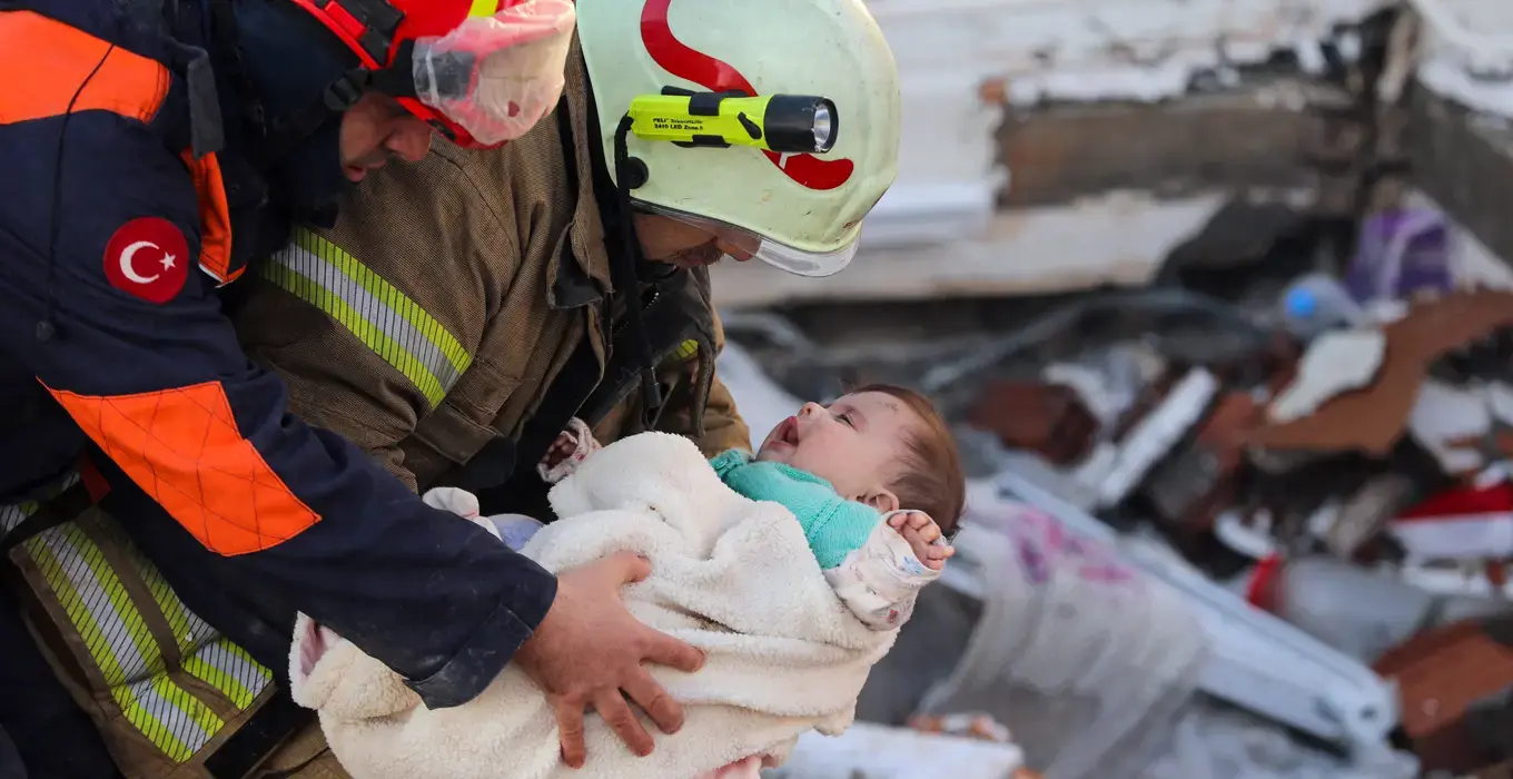 Baby Ayse Vera is being rescued by a team of first responders in Hatay, Türkiye. Photo: AytugCan Sencar / ANADOLU AGENCY / Anadolu Agency via AFP