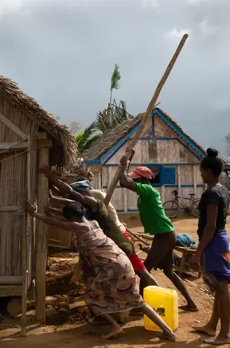 Neighbours in Tsiatosika village, 15 km from Mananjary, come together to repair a cyclone-damaged house. They will do this for every damaged house in the village.