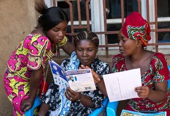 Women from the Somuma community group siting together and providing feedback on the new leaflets that is going to be distributed to the community about Ebola.