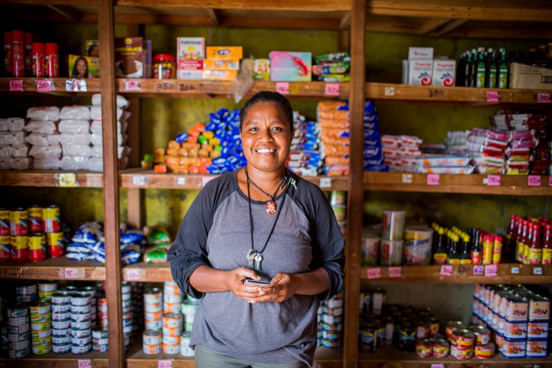 A woman stands in her store in Vanuatu