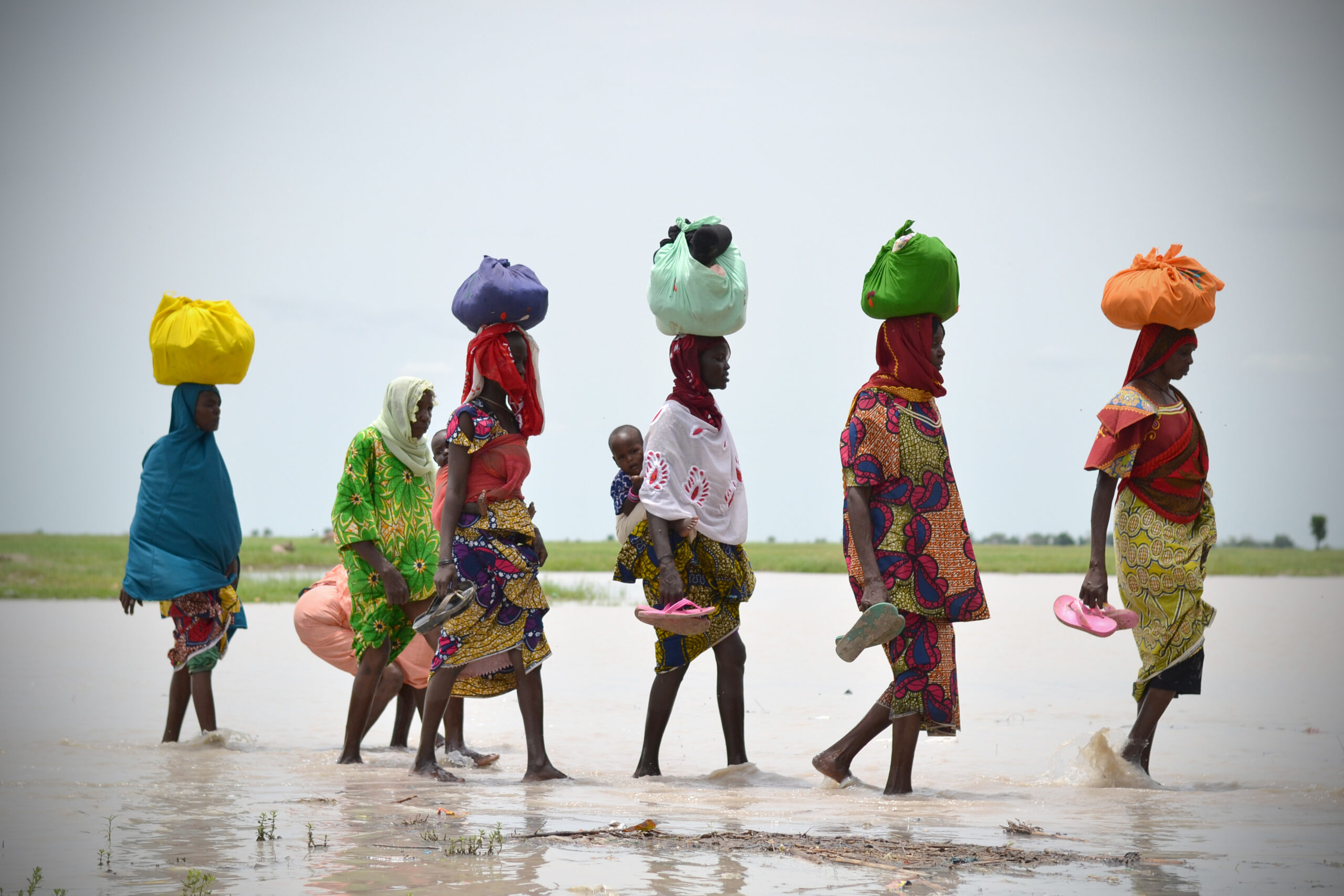 People crossing flooded area in Borno State, Nigeria