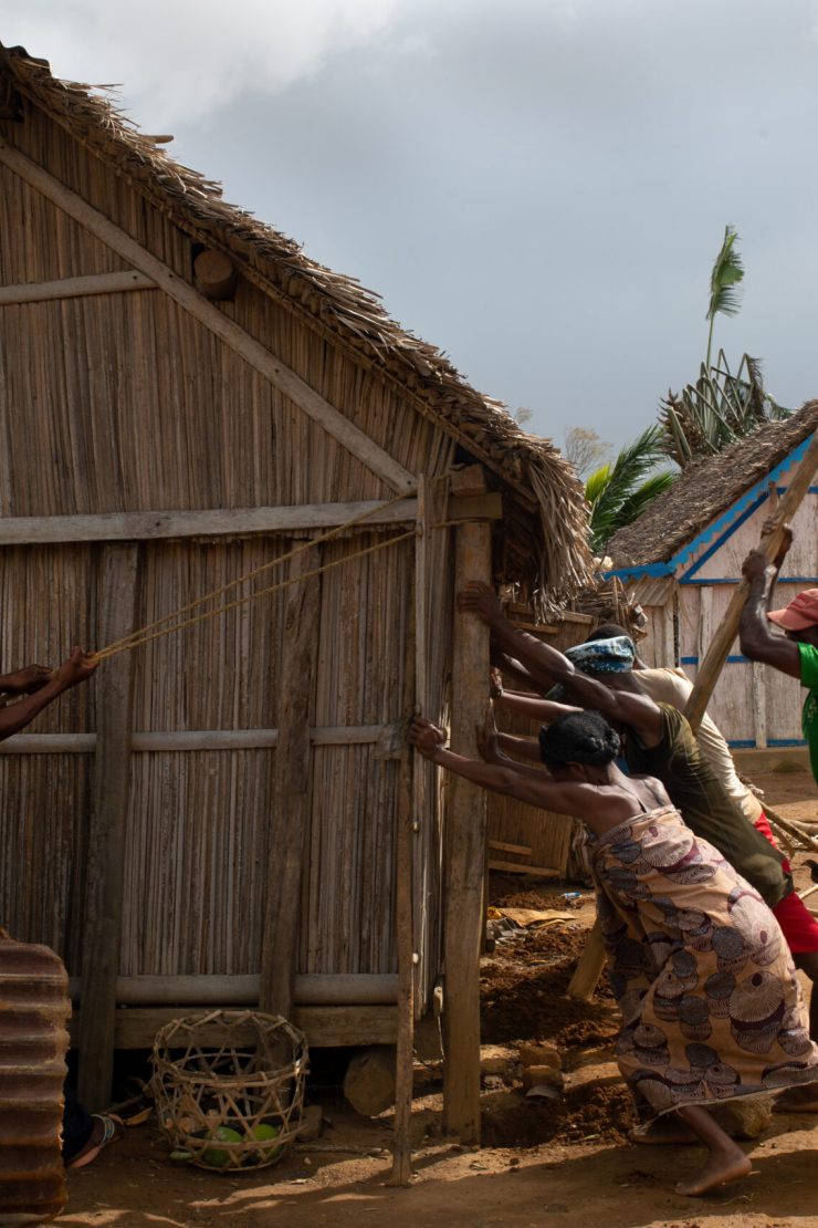 Neighbours in Tsiatosika village, 15 km from Mananjary, come together to repair a cyclone-damaged house. They will do this for every damaged house in the village.