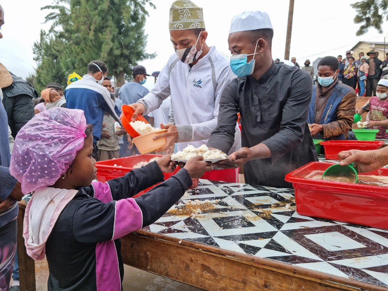 A child receives a hot meal distributed by volunteers as part of the support offered to flood-affected families in Madagascar