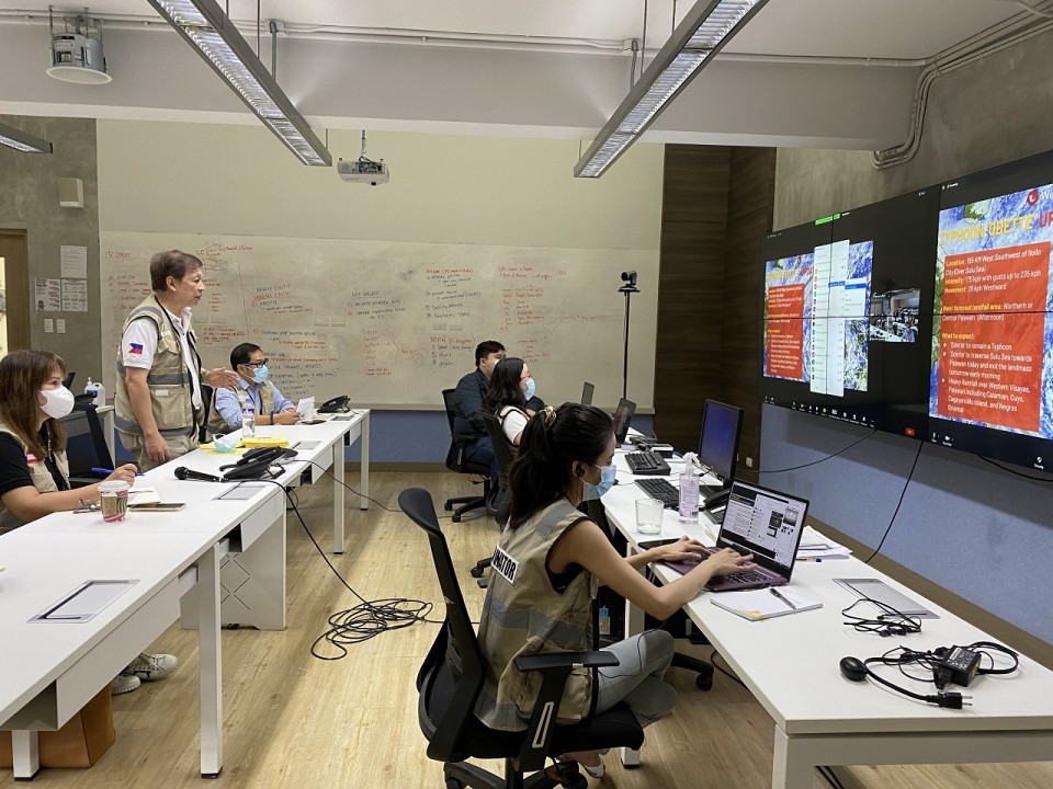 Staff monitor an on-going disaster by watching live updates on the giant screen at the business-led Emergency Operations Center run by the Philippine Disaster Resilience Foundation (PDRF)