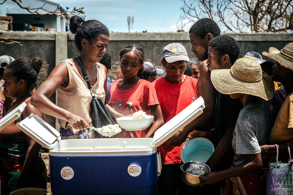 A malagasy woman distributes a hot meal to affected people after the cyclone in Mananjary
