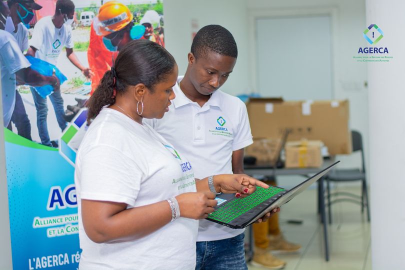 Two people looking at a laptop.