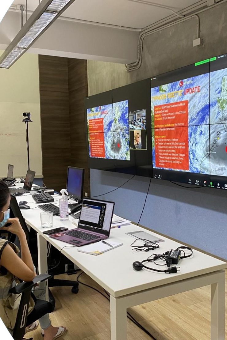 A few staff members of the Philippine Disaster Resilience Foundation (PDRF), a CBi Member Network, monitor weather patterns and emergencies via the HANDA platform in the PDRF Business-Led Emergency Operations Center (BEOC) in Clark. Photo: PDRF