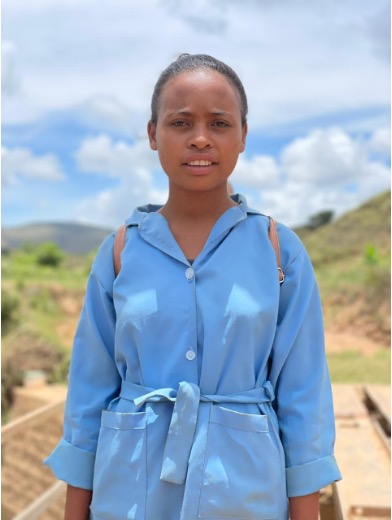 Ny Avo is a 15-year-old student who used to have to walk two hours to get to school, and couldn’t make it there in case of rain and flooding. Now, thanks to the bridge, she feels safer going to school and misses less days. Photo: PSHP Mada