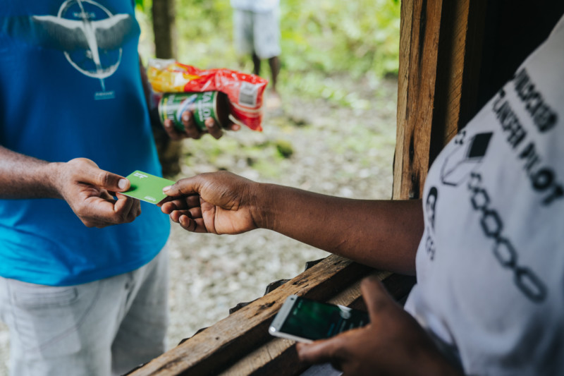 Sanma province supplier and customer complete their first live transaction as part of an Unblocked cash transfer initiative powered by blockchain and implemented by the Vanuatu Business Resilience Council and Oxfam. Photo: Groovy Banana/VBRC