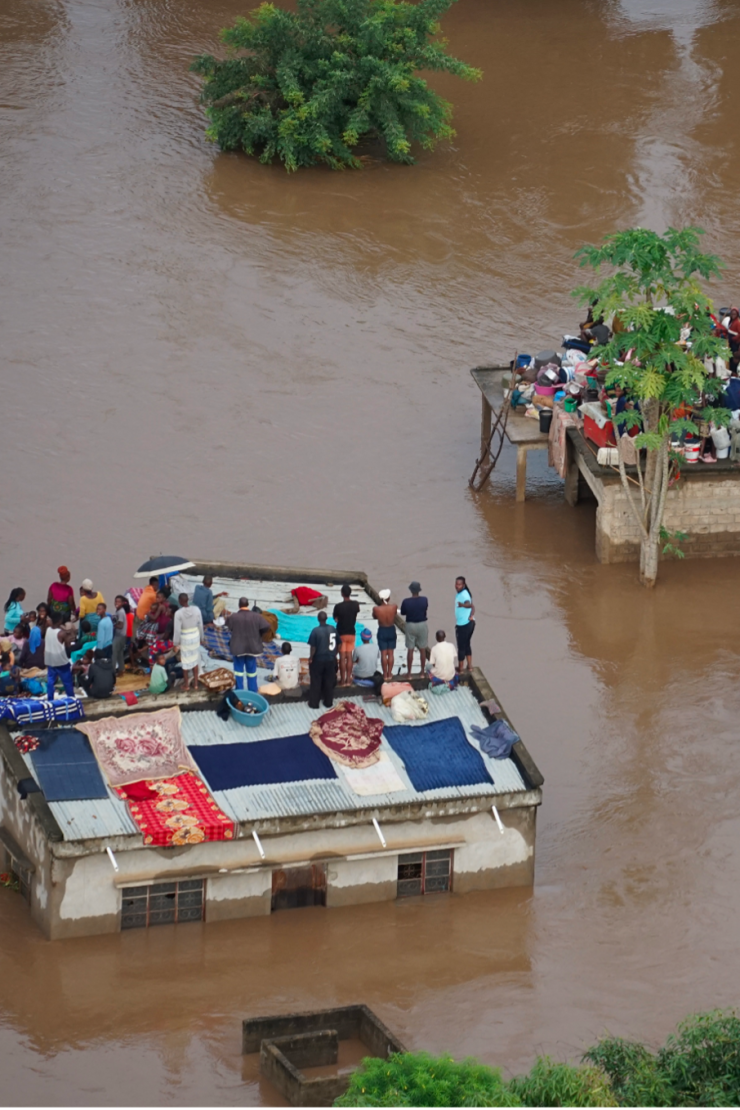 People stranded on top of houses in the aftermath of the floods in Mozambique, January 2026. Photo: Mercy Air