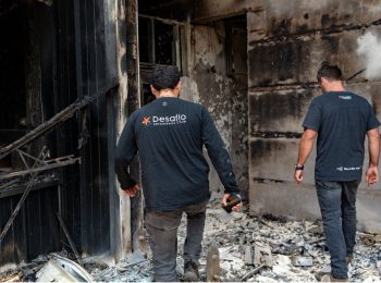 The Desafío Levantemos Chile emergency team assesses the damage caused by the fire in Penco, Chile. Photo: Desafío